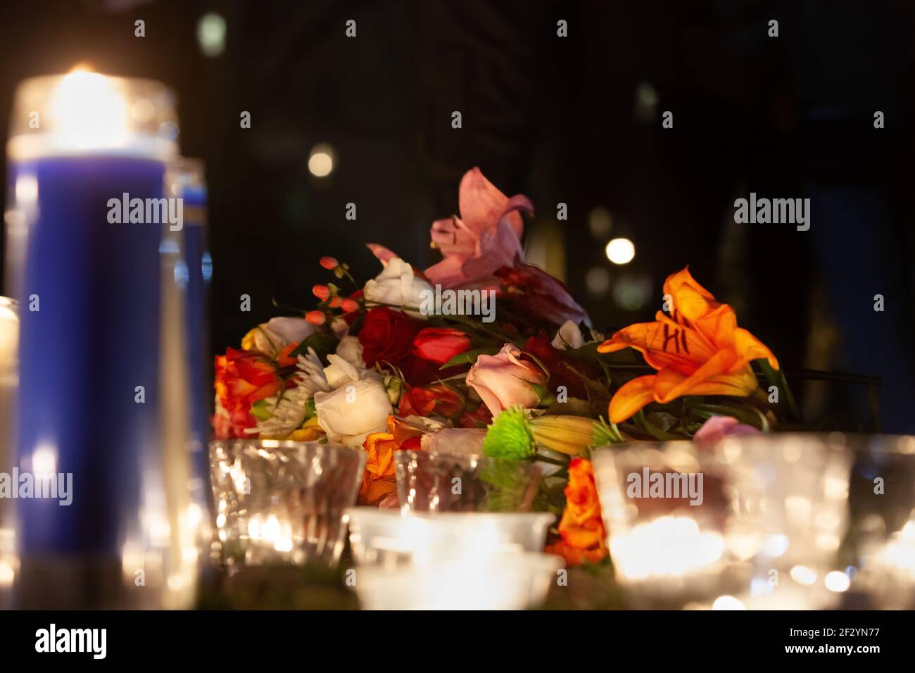 Washington, DC, USA, 13 March, 2021.  Pictured: Flowers and candles at the memorial during a candlelight vigil for Breonna Taylor.  The vigil marked the one year anniversary of Taylor's killing by Louisville Police officers, and called for them to be held accountable for her death.  Credit: Allison C Bailey/Alamy Live News Stock Photo