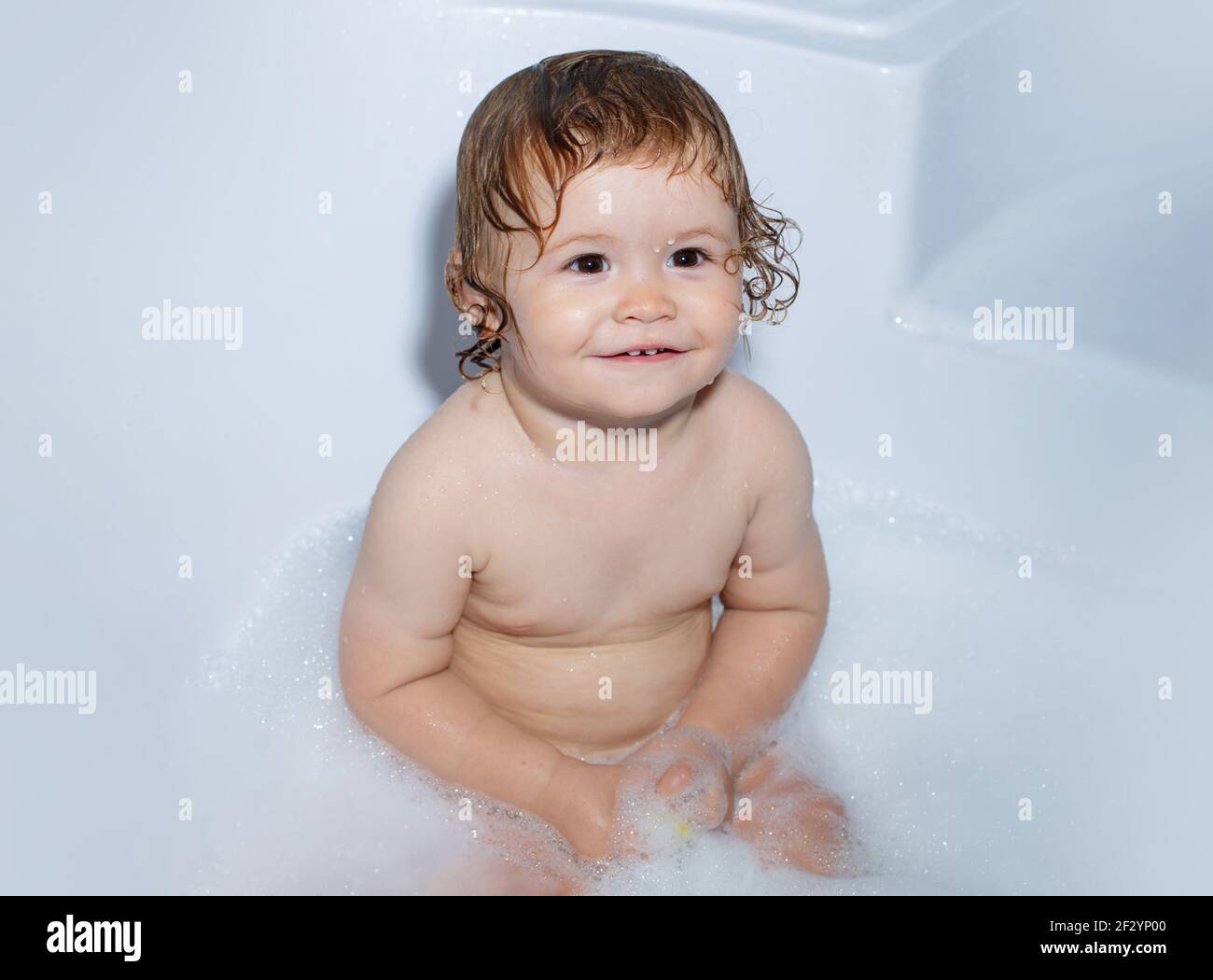 Todler in shower, funny infant in shower. Little baby taking bath