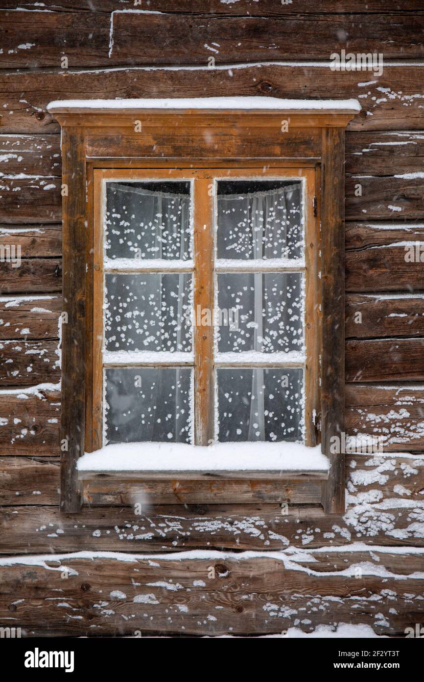 Snowy wiindow of an old log building in Seurasaari Open-Air Museum in Helsinki, Finland Stock Photo