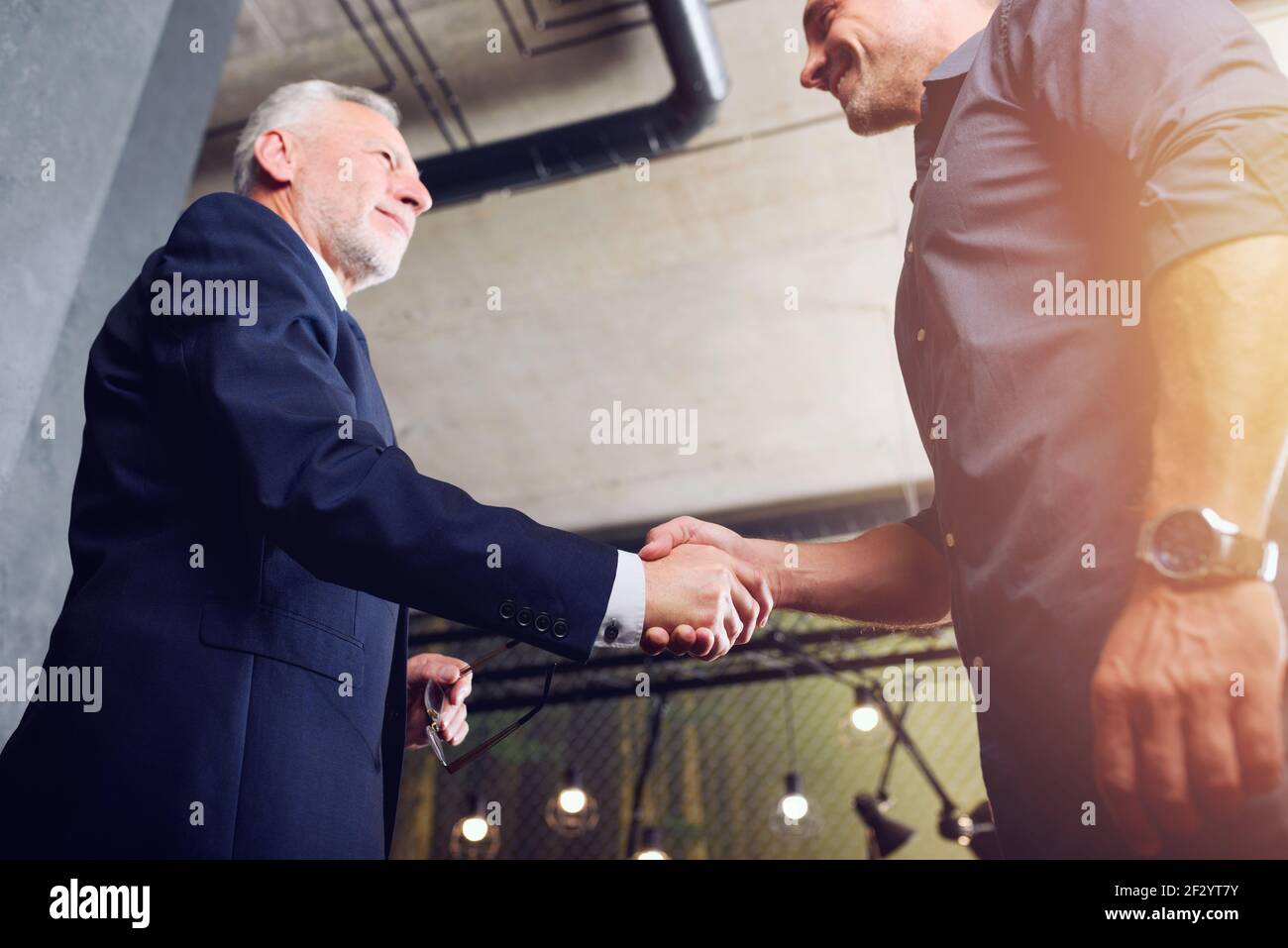 Handshaking business person in office. concept of teamwork and partnership. Stock Photo