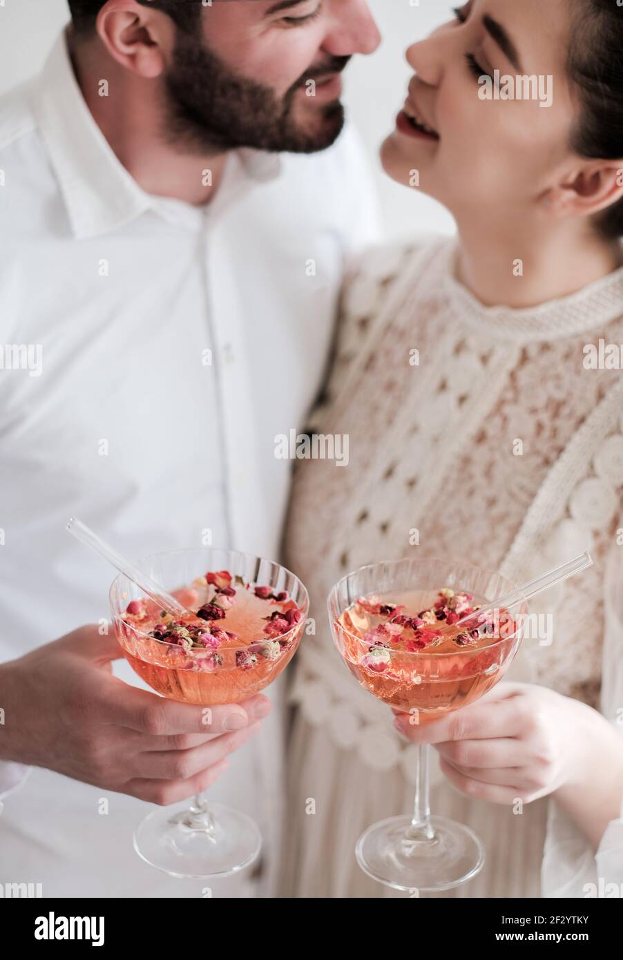 Happy couple holding glasses of sparkling champagne cocktail in hands Stock Photo