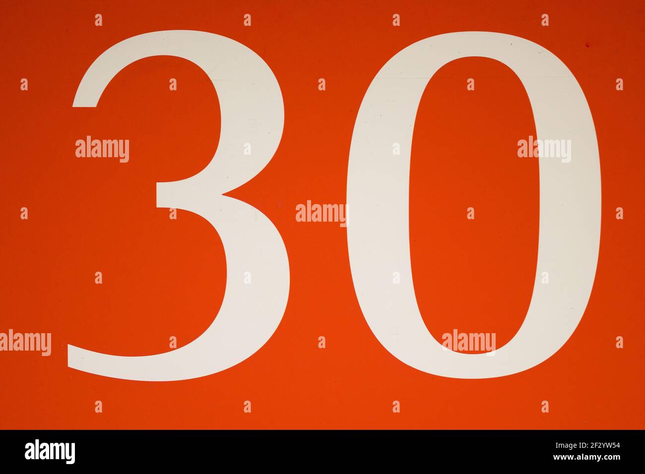 Colorful red and white sign with the number thirty - 30 - stencilled in ...