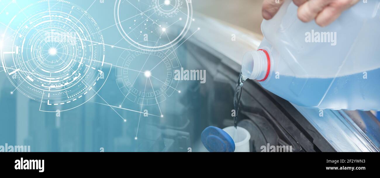 Hands of mechanic pouring blue windshield washer fluid in a car; panoramic banner Stock Photo