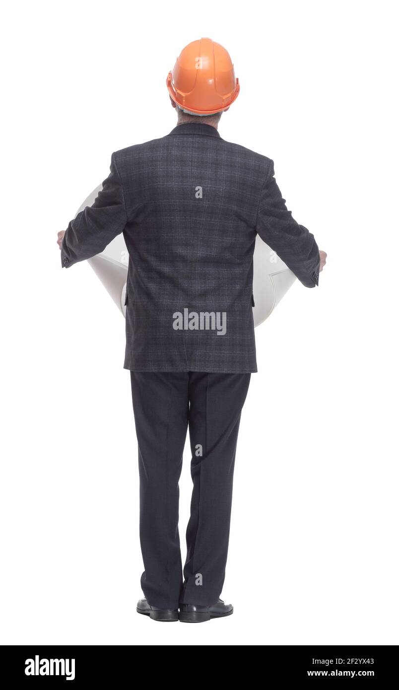 rear view. architect with a drawing standing in front of a white wall. Stock Photo