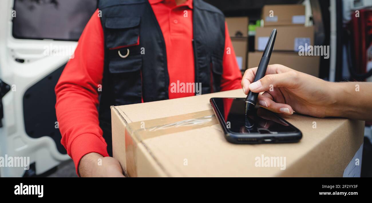 Express courier delivering cardboard box order to customer - Deliver and online buying concept Stock Photo