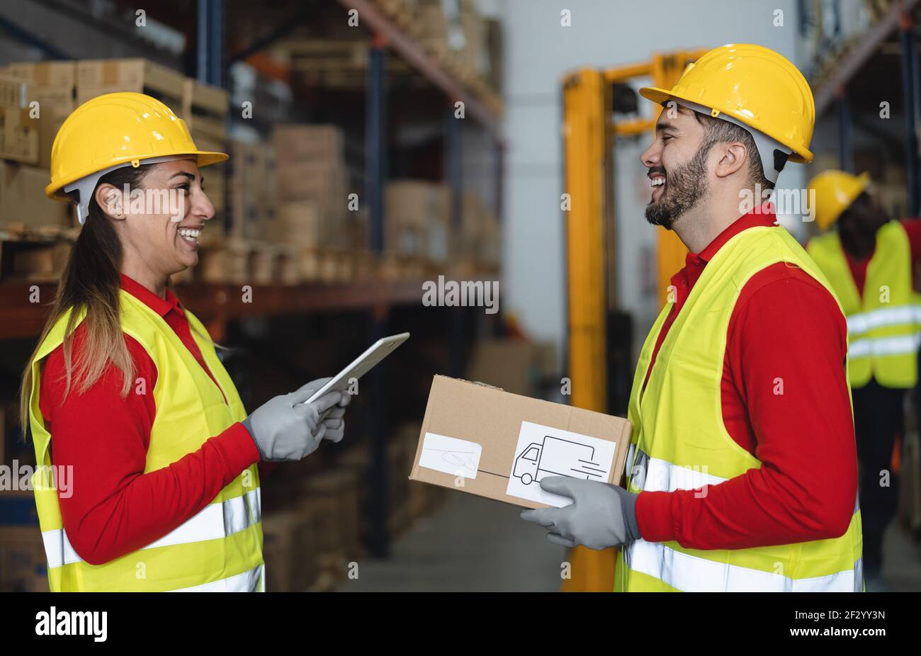 Warehouse workers doing inventory using digital tablet and loading delivery boxes plan - Logistic and industry concept Stock Photo