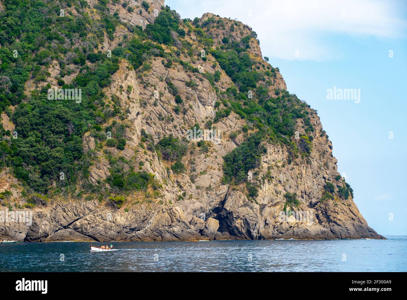Small fishing boat is navigating in the Ligurian sea near the Portofino promontory Stock Photo