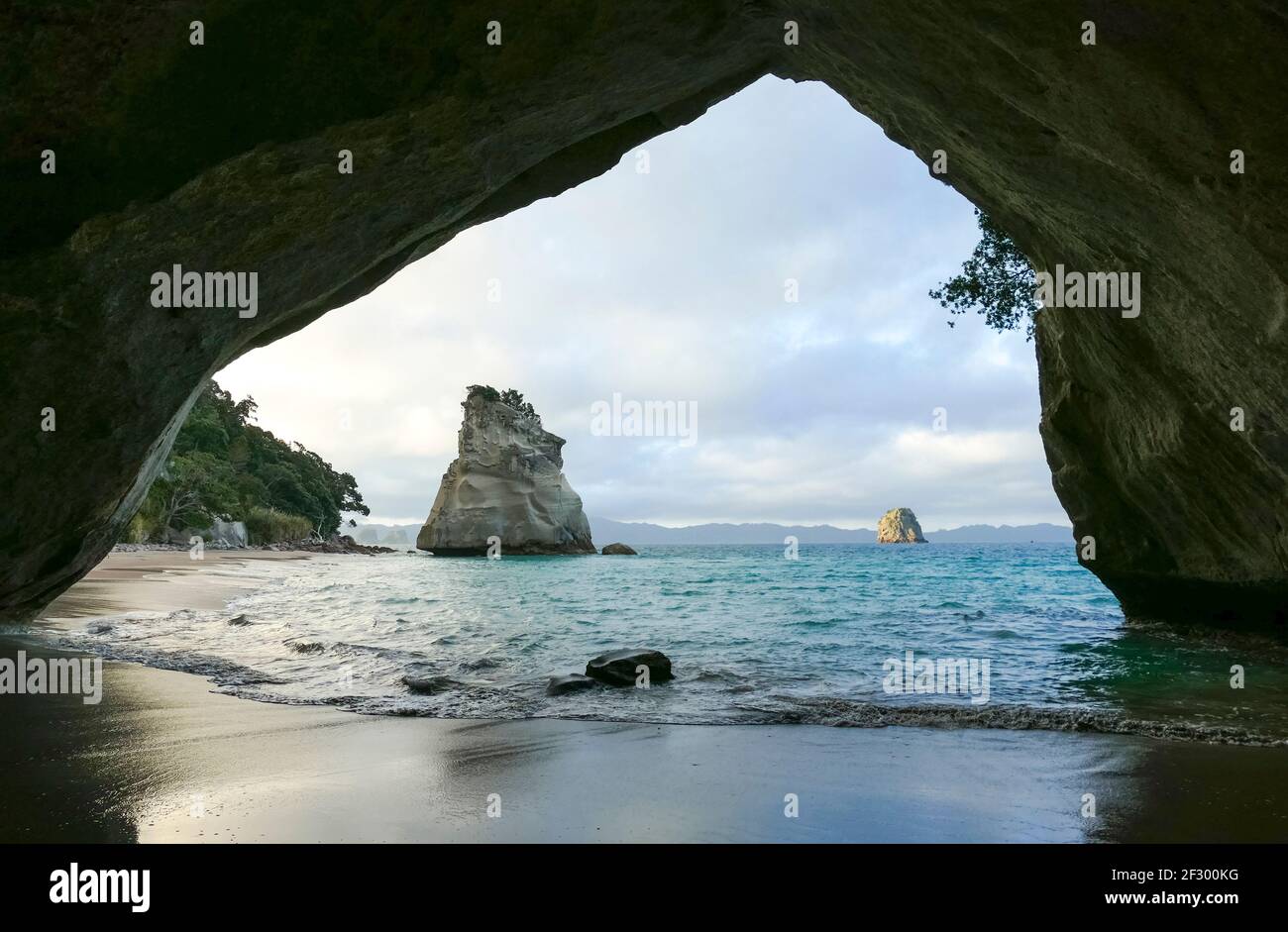 Te Hoho Rock seen through a rock arch at a coastal area named Cathedral ...