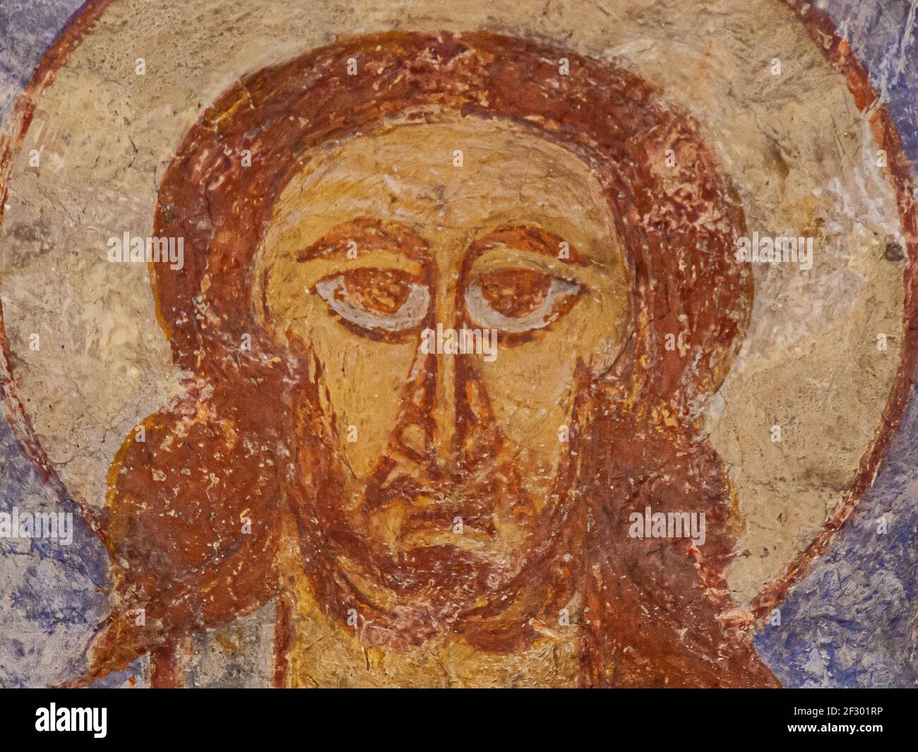 Christ with big almond-shaped eyes, a 800 years old al fresco wall-painting, Övraby church, Sweden, November 6, 2009 Stock Photo