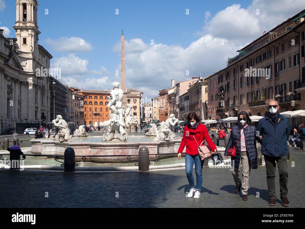 Rome, ITALY- 13 March 2021: People enjoy a sunny day by the Spanish Steps on Piazza di Spagna in downtown Rome before the government tightens restrictions across most of the country from March 15, facing a 'new wave' of Covid-19 Stock Photo