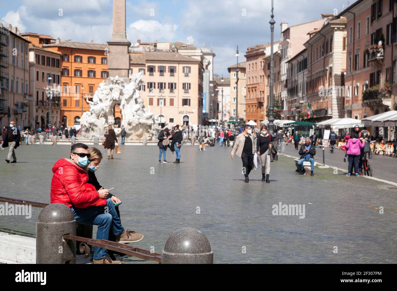 Rome, ITALY- 13 March 2021: People enjoy a sunny day by the Spanish Steps on Piazza di Spagna in downtown Rome before the government tightens restrictions across most of the country from March 15, facing a 'new wave' of Covid-19 Stock Photo