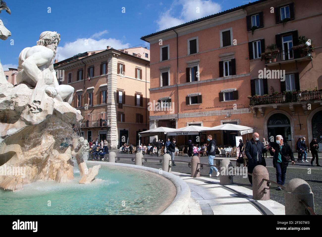 Rome, ITALY- 13 March 2021: People enjoy a sunny day by the Spanish Steps on Piazza di Spagna in downtown Rome before the government tightens restrictions across most of the country from March 15, facing a 'new wave' of Covid-19 Stock Photo