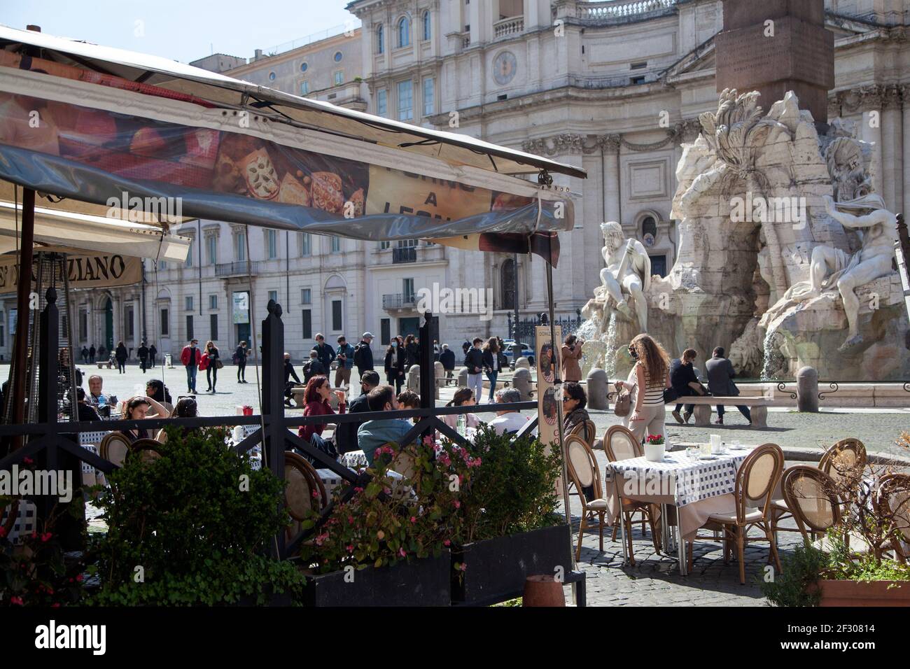 Rome, ITALY- 13 March 2021: People enjoy a sunny day by the Spanish Steps on Piazza di Spagna in downtown Rome before the government tightens restrictions across most of the country from March 15, facing a 'new wave' of Covid-19 Stock Photo