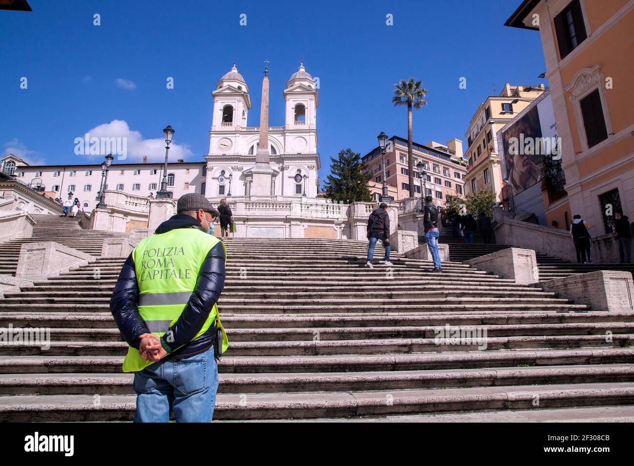 Rome, ITALY- 13 March 2021: People enjoy a sunny day by the Spanish Steps on Piazza di Spagna in downtown Rome before the government tightens restrictions across most of the country from March 15, facing a 'new wave' of Covid-19 Stock Photo