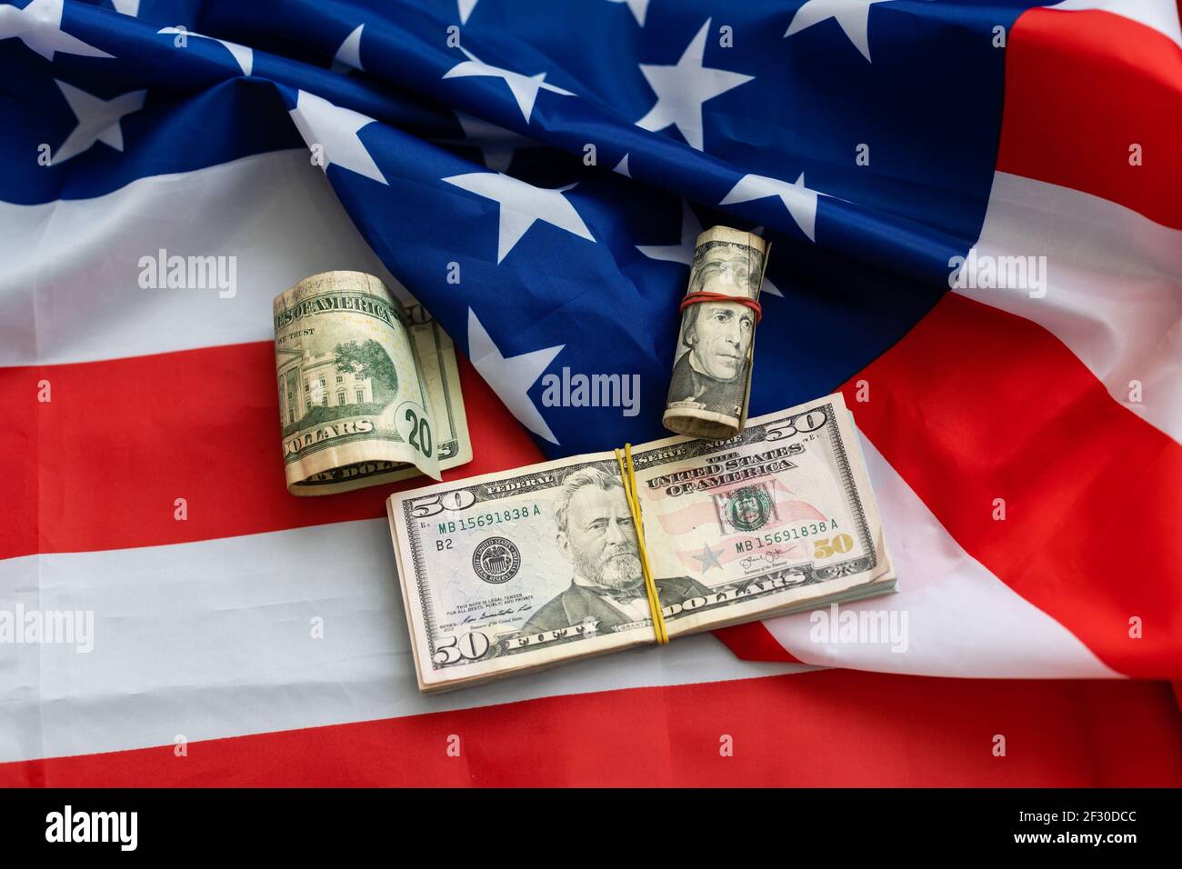 Stack of money on American Flag. dollars Stock Photo - Alamy