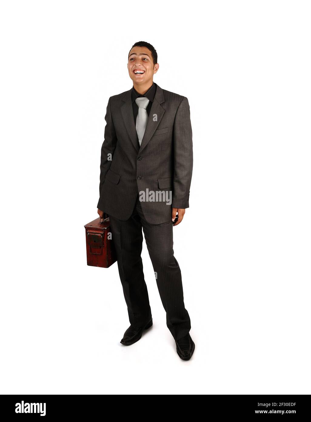 Man holding an old suitcase isolated over white background Stock Photo