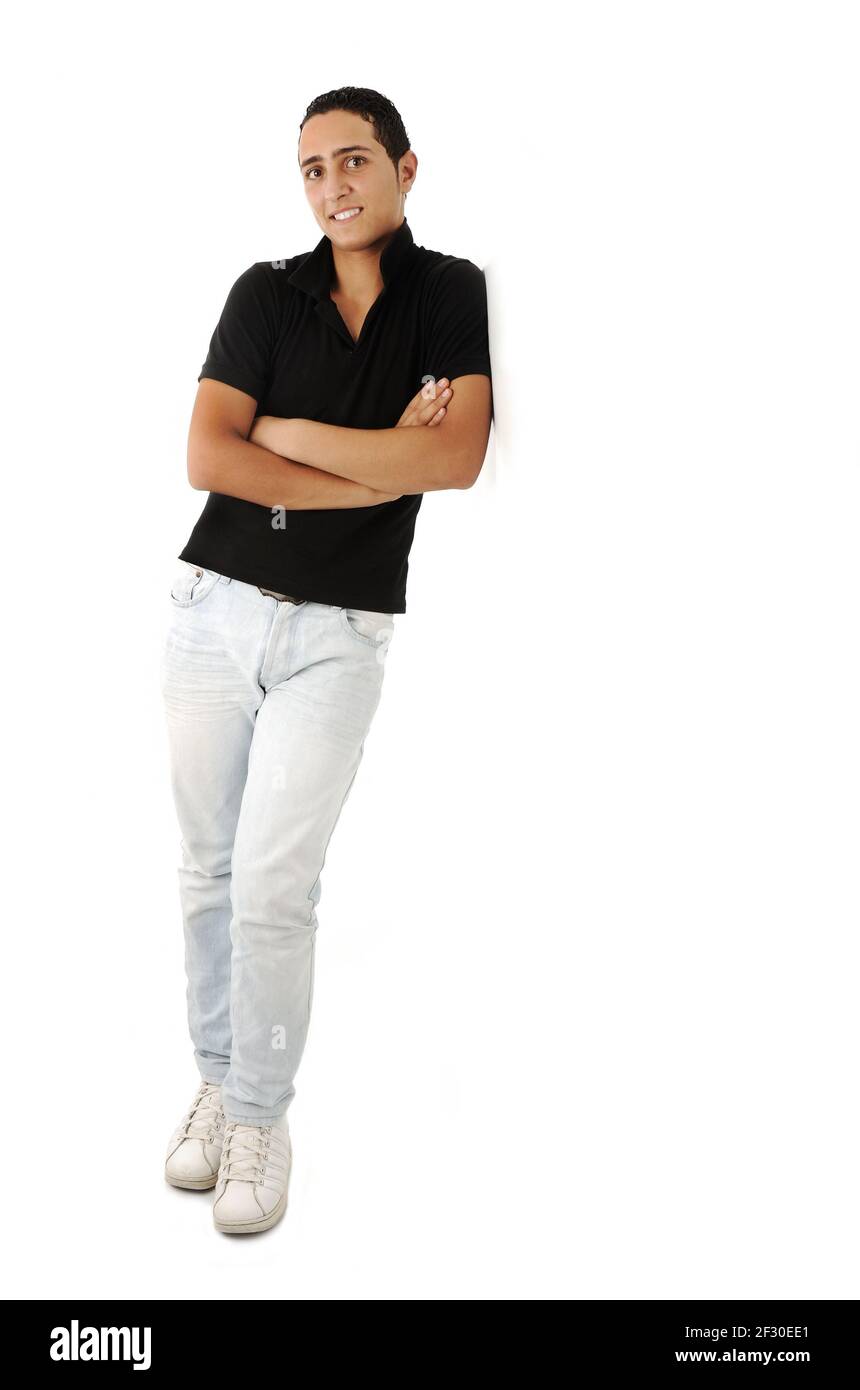 Arabic guy standing against the wall smiling, isolated Stock Photo
