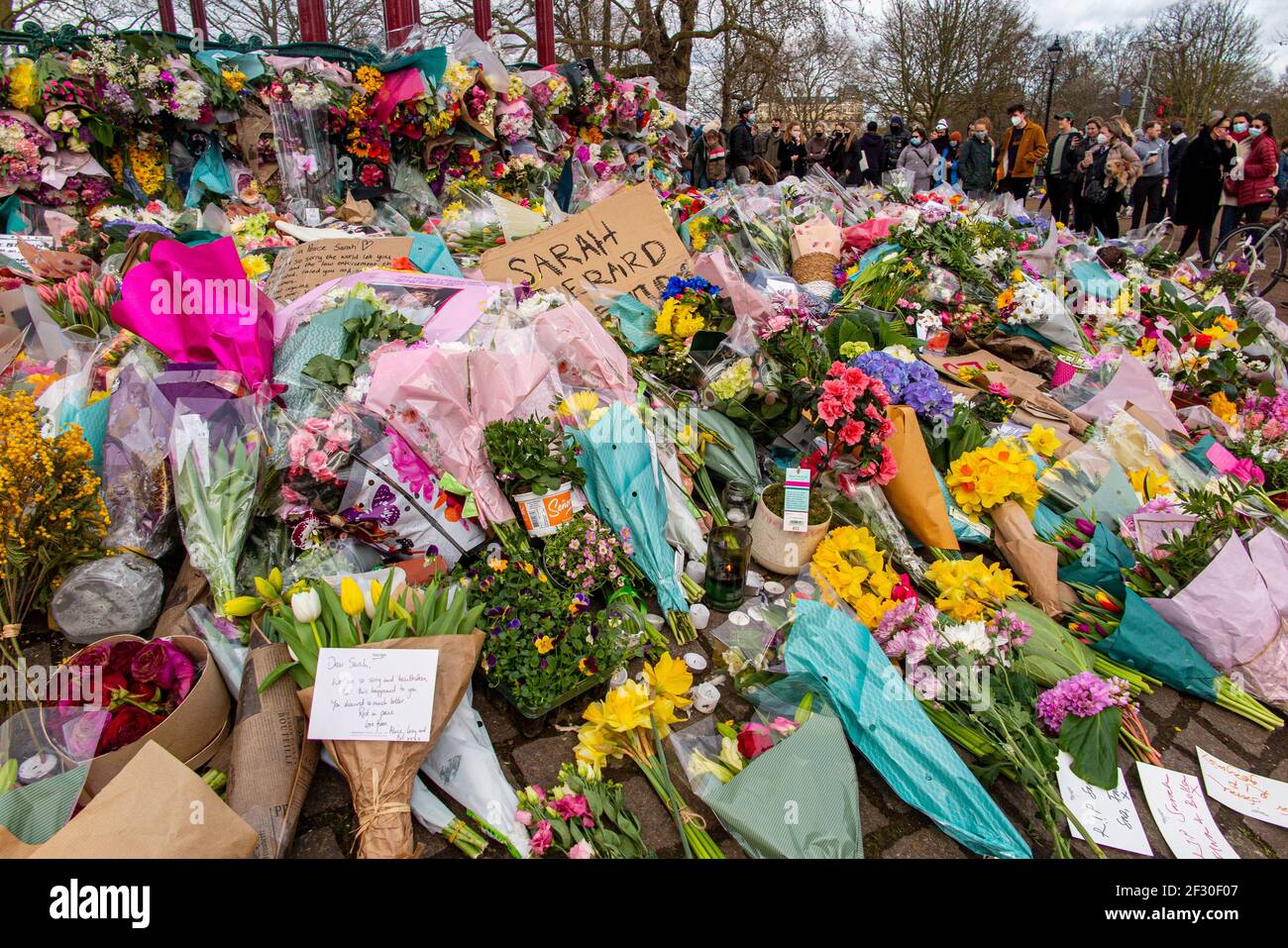 14th March 2021 - families pay their respects and lay floral tributes for Sarah Everard on Clapham Common, the day after the cancelled vigil Stock Photo