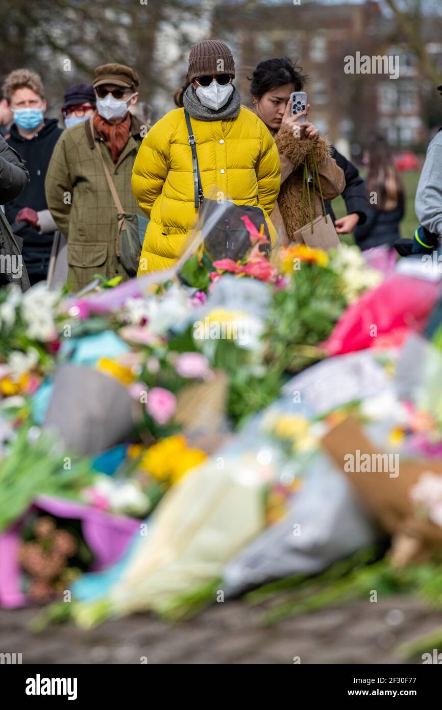 14th March 2021 - families pay their respects and lay floral tributes for Sarah Everard on Clapham Common, the day after the cancelled vigil Stock Photo