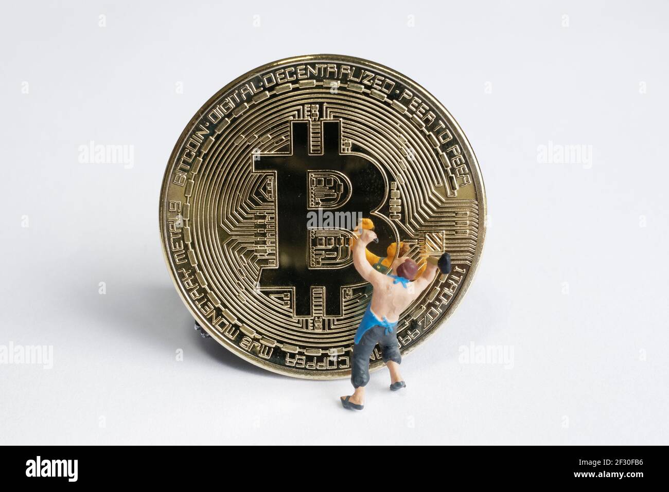 macro miner figures working on bitcoin. virtual cryptocurrency mining concept Stock Photo