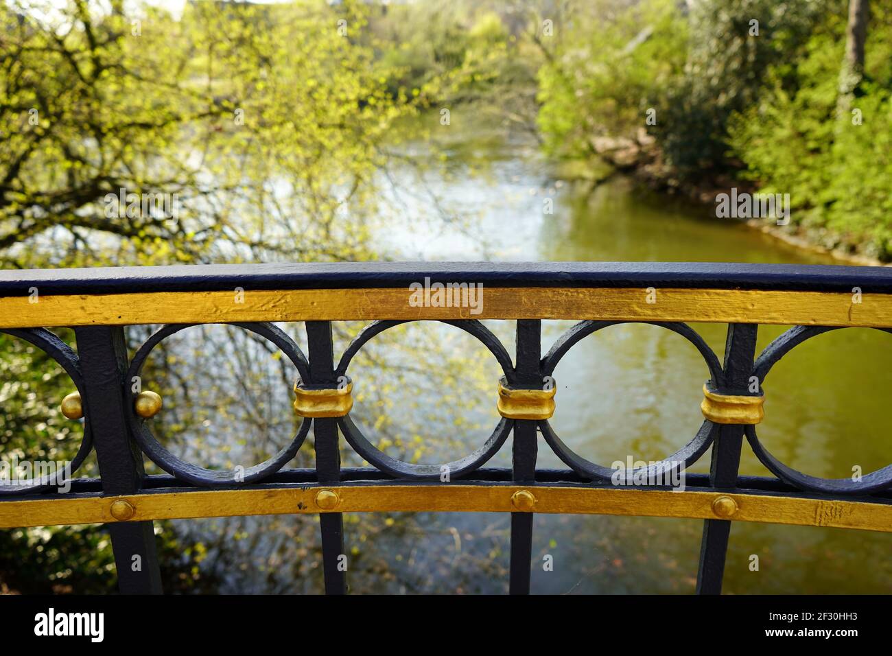 Railing of the Goldene Brücke (Golden Bridge) in the public park Hofgarten in Düsseldorf. It is the oldest footbridge in town, built in 1853. Stock Photo