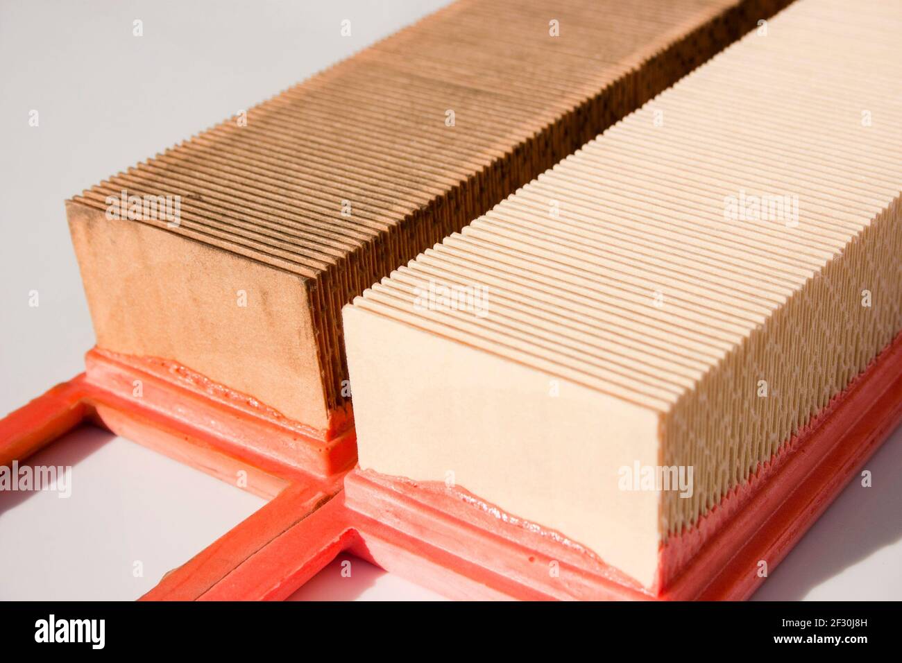 Old and new engine air filter. Replacing the air filter of the car