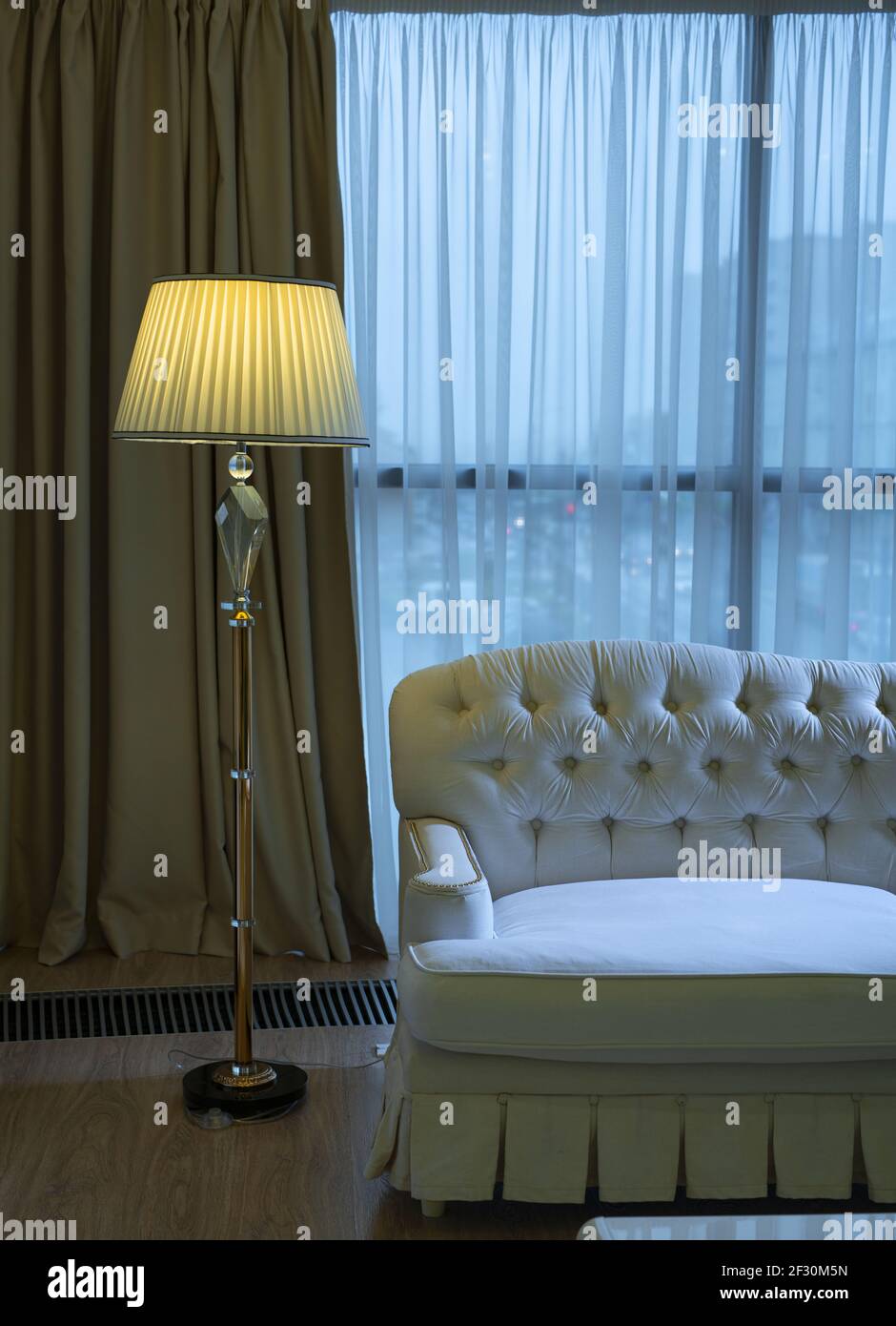Interior of cozy room with sofa and floor lamp Stock Photo - Alamy