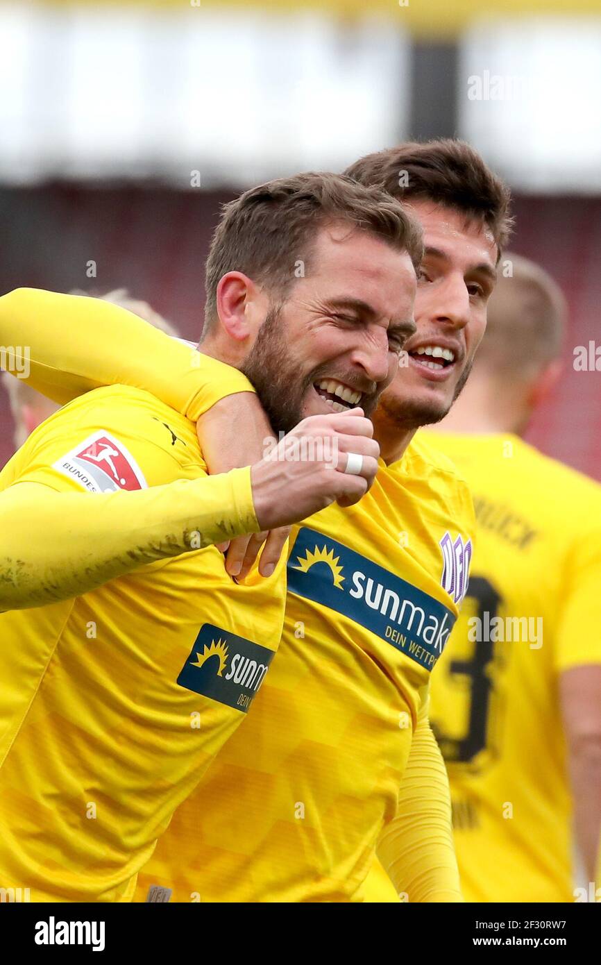 Nuremberg, Germany. 14th Mar, 2021. Football: 2nd Bundesliga, 1. FC Nürnberg - VfL Osnabrück, Matchday 25 at Max-Morlock-Stadion. Marc Heider (l) of VfL Osnabrück celebrates with his colleague Bashkim Ajdini after scoring the goal to make it 1:1. Credit: Daniel Karmann/dpa - IMPORTANT NOTE: In accordance with the regulations of the DFL Deutsche Fußball Liga and/or the DFB Deutscher Fußball-Bund, it is prohibited to use or have used photographs taken in the stadium and/or of the match in the form of sequence pictures and/or video-like photo series./dpa/Alamy Live News Stock Photo