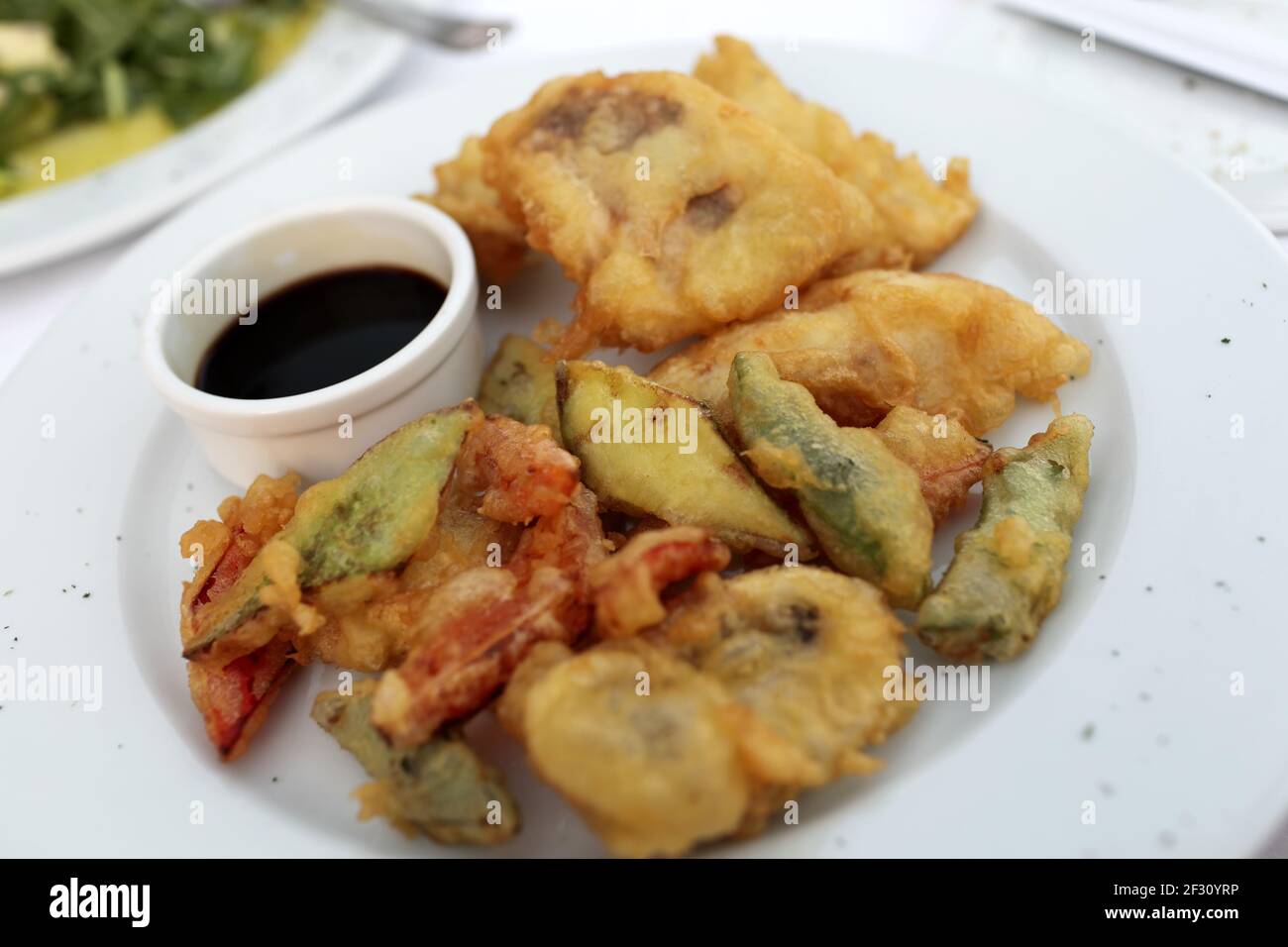 Plate with tempura fish and vegetables in the restaurant Stock Photo