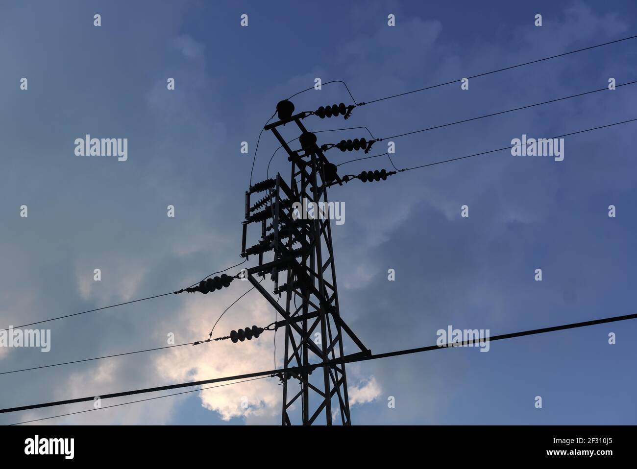 A low angle shot of power lines on the cloudy sky background Stock ...