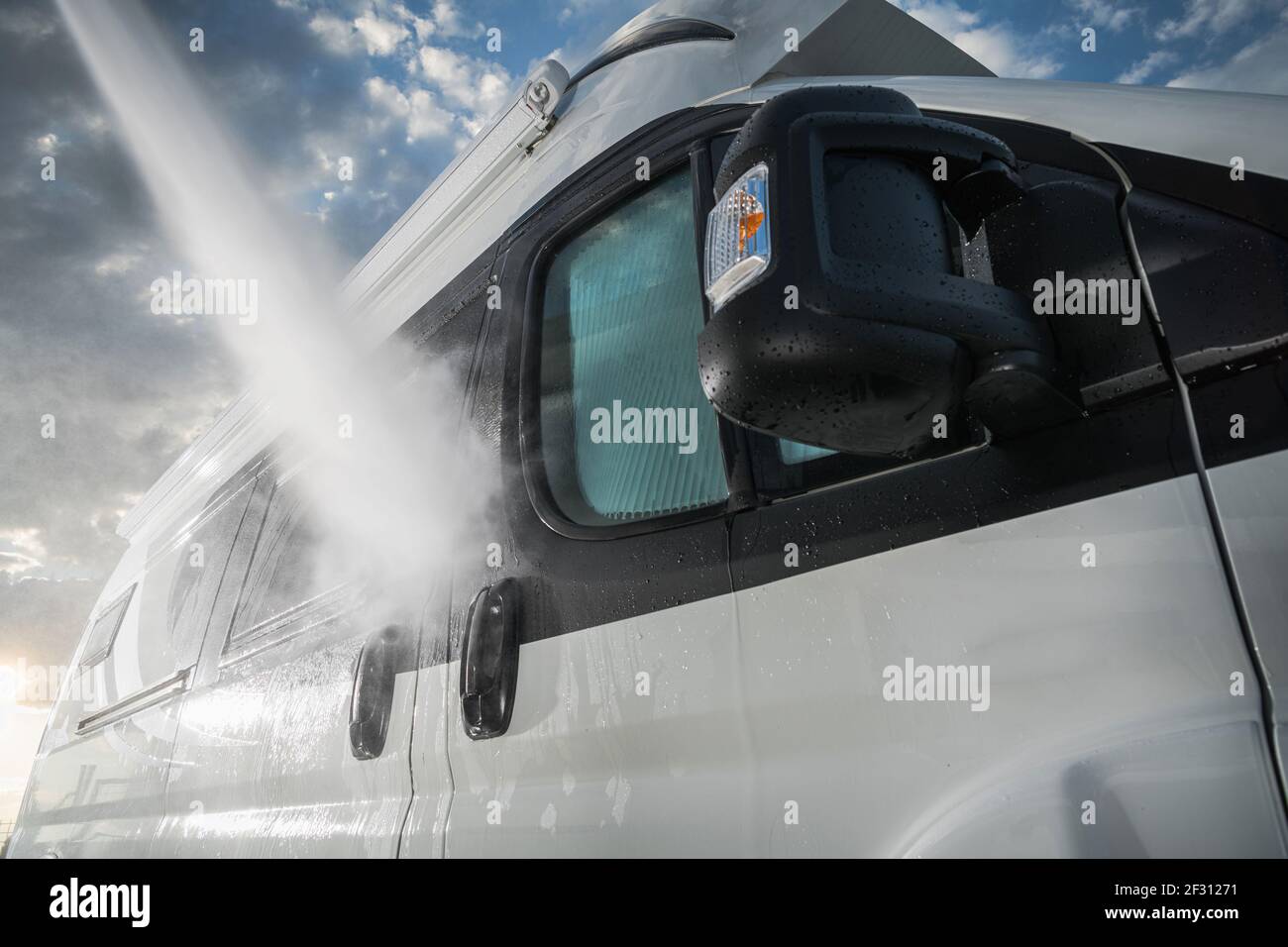 Summer Season Preparation. Pressure Washing RV Camper Van Close Up. Recreational Vehicle Maintenance. RV Industry. Stock Photo