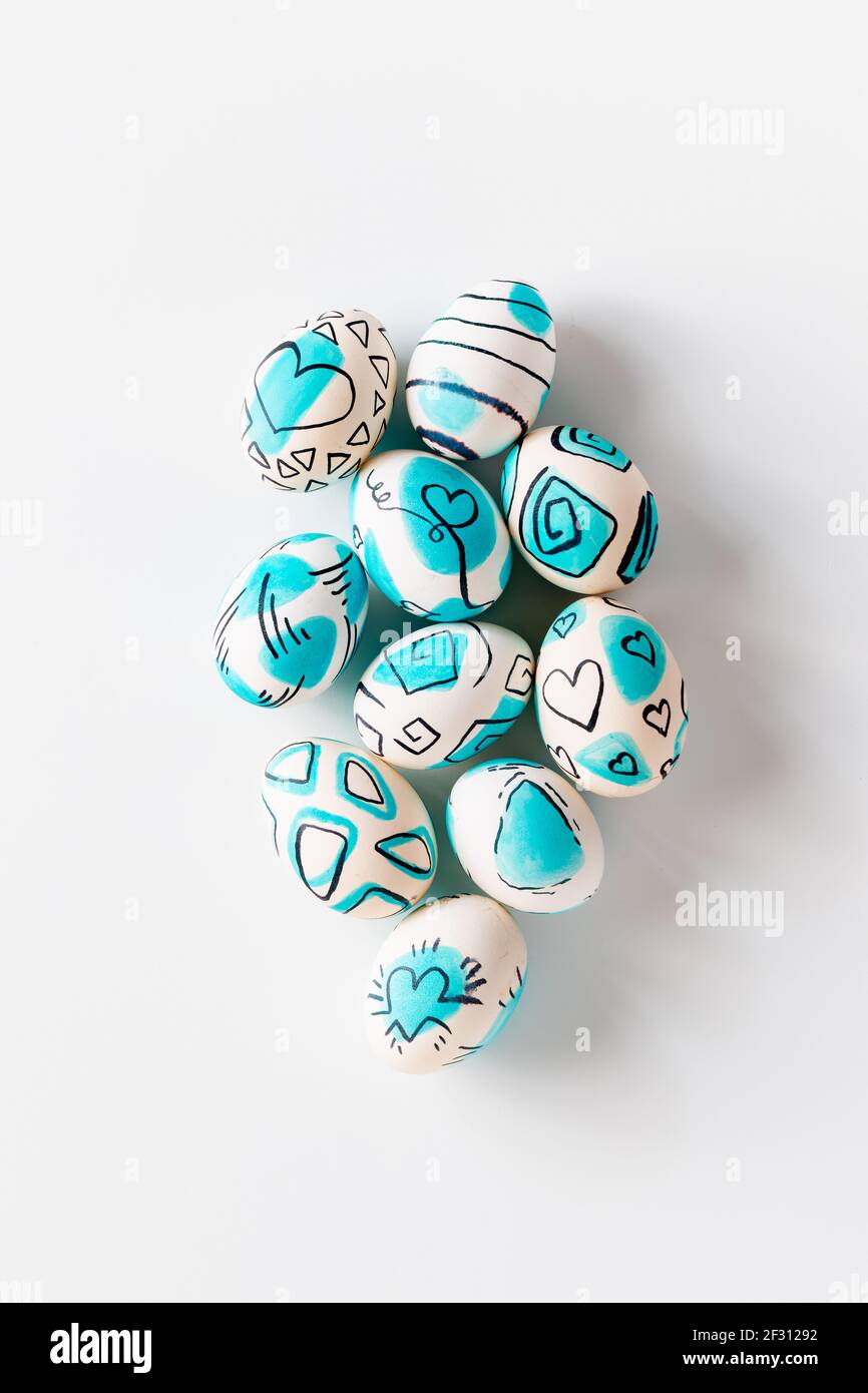 Creative trendy painted easter eggs on white background. Easter ideas. Stock Photo