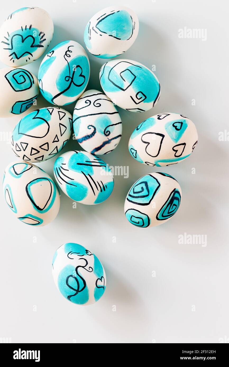 Creative trendy painted easter eggs on white background. Easter ideas. Stock Photo