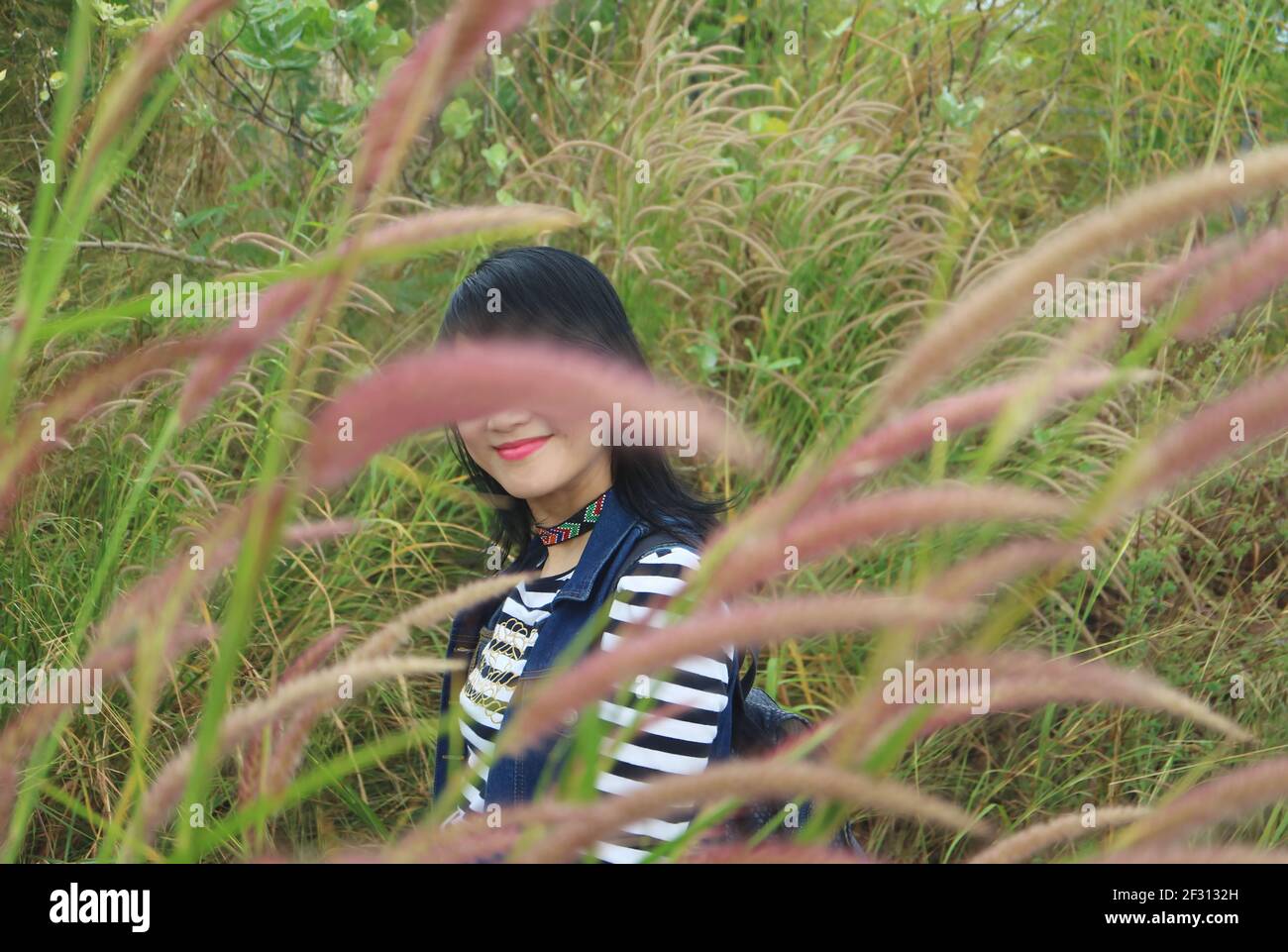 One Happy Hiker Smiling in a Beautiful Pennisetum Field Stock Photo