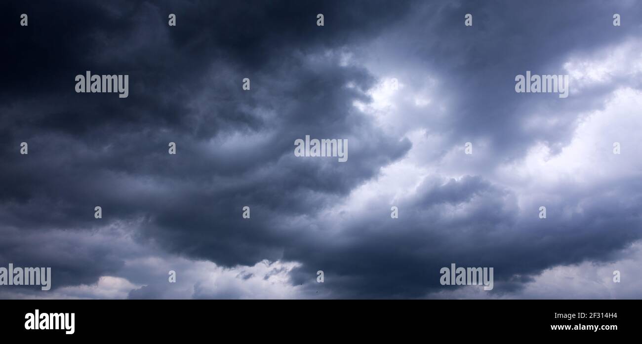 Dark ominous grey storm clouds. Dramatic sky. Stock Photo