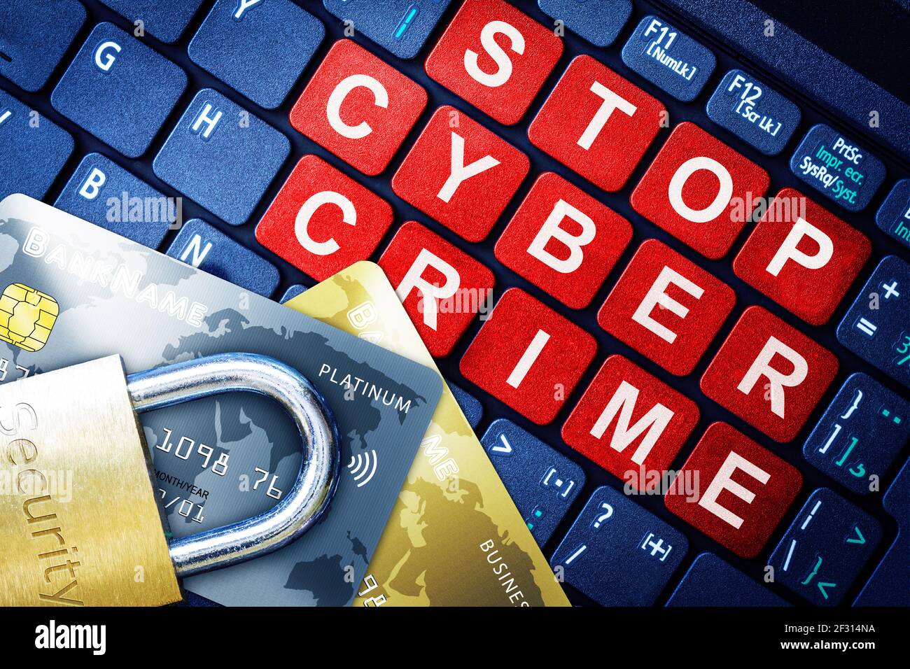 Stop Cyber Crime in red keys on high-tech computer keyboard background with security engraved lock on fake credit cards. Concept of Internet security, Stock Photo