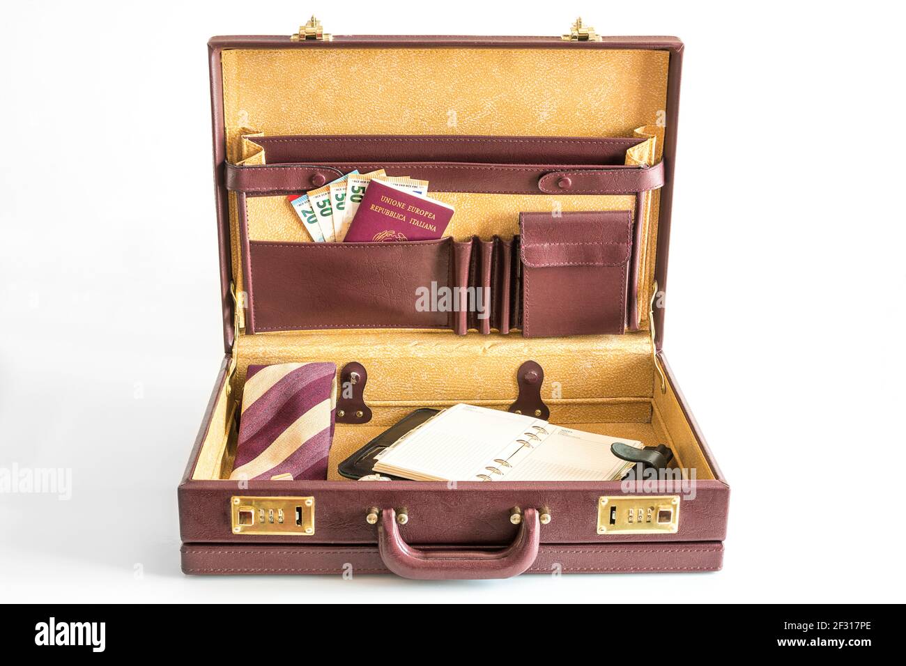 24 hour suitcase with passport, banknotes, chronograph, organizer and tie with cufflinks ready to go Stock Photo