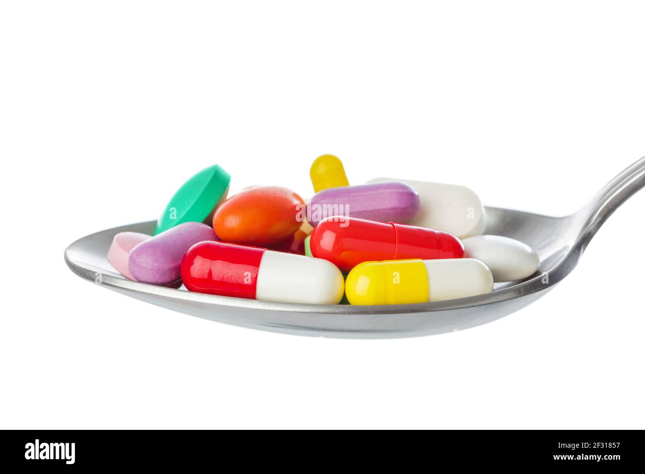 Spoon with pills Stock Photo
