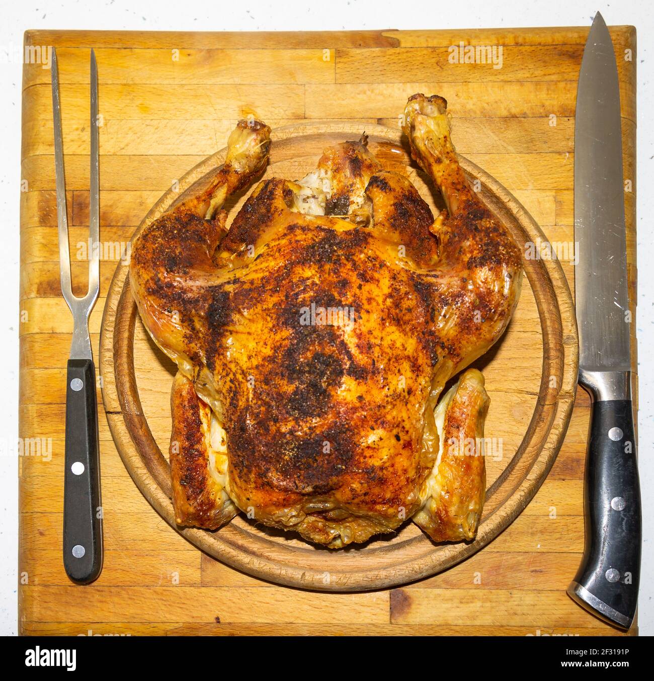 Roast chicken on carving board. Stock Photo