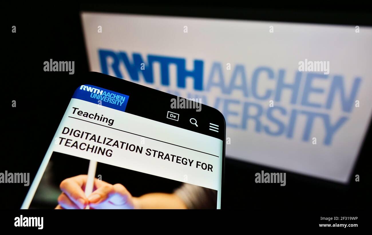 Cellphone with website of Rheinisch-Westfälische Technische Hochschule Aachen on screen in front of logo. Focus on top-left of phone display. Stock Photo