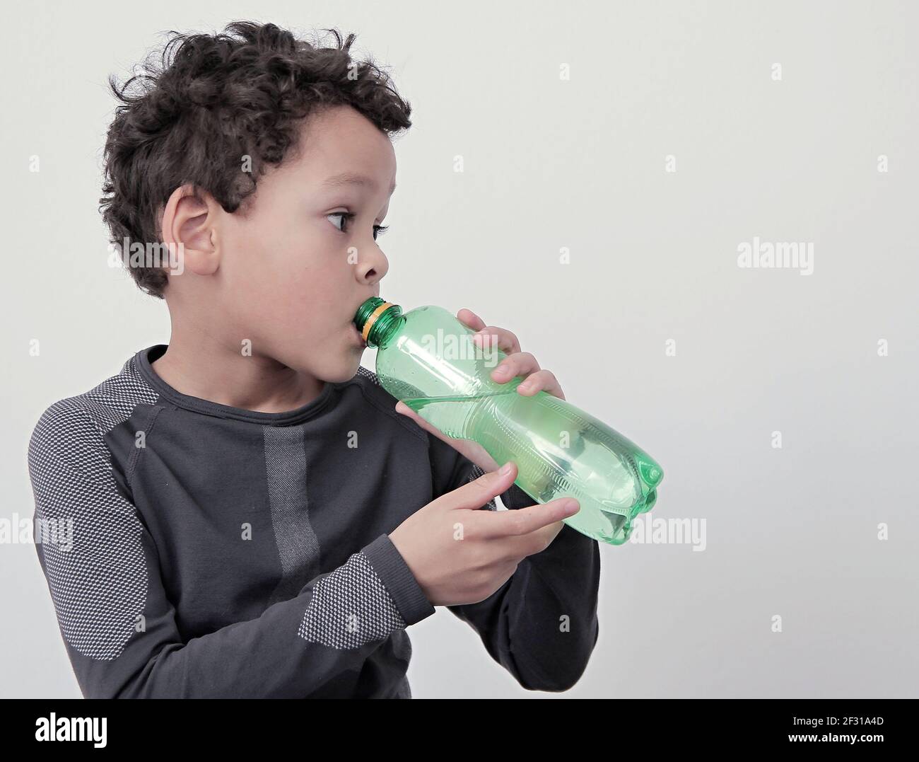 https://c8.alamy.com/comp/2F31A4D/boy-drinking-water-from-a-bottle-with-white-background-stock-photo-2F31A4D.jpg