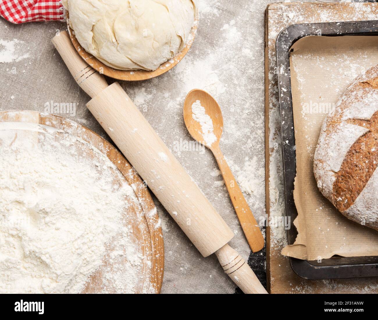 White wheat flour heaped on a round wooden board Stock Photo