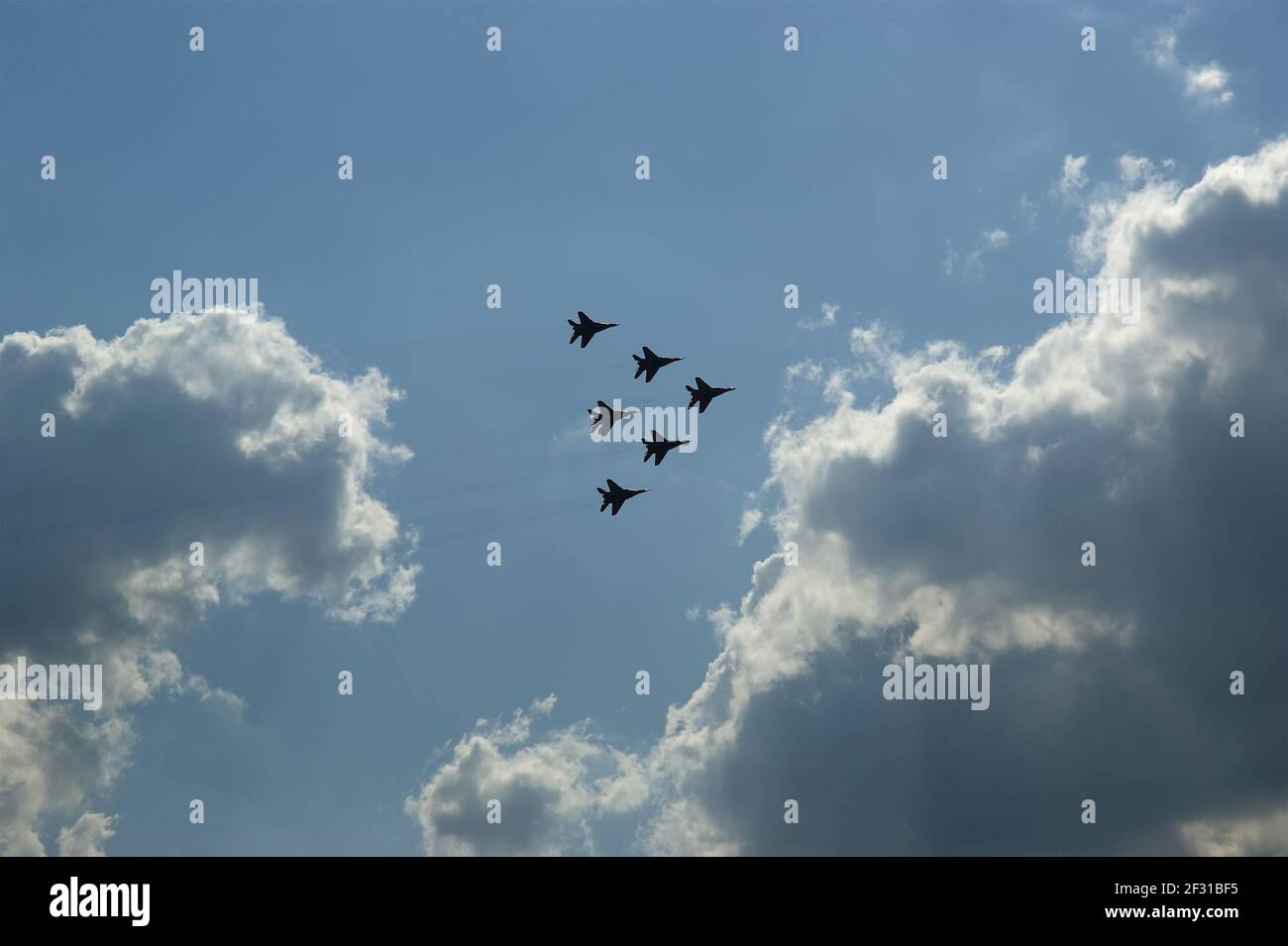 Flight of modern combat fighters on the sky background Stock Photo - Alamy
