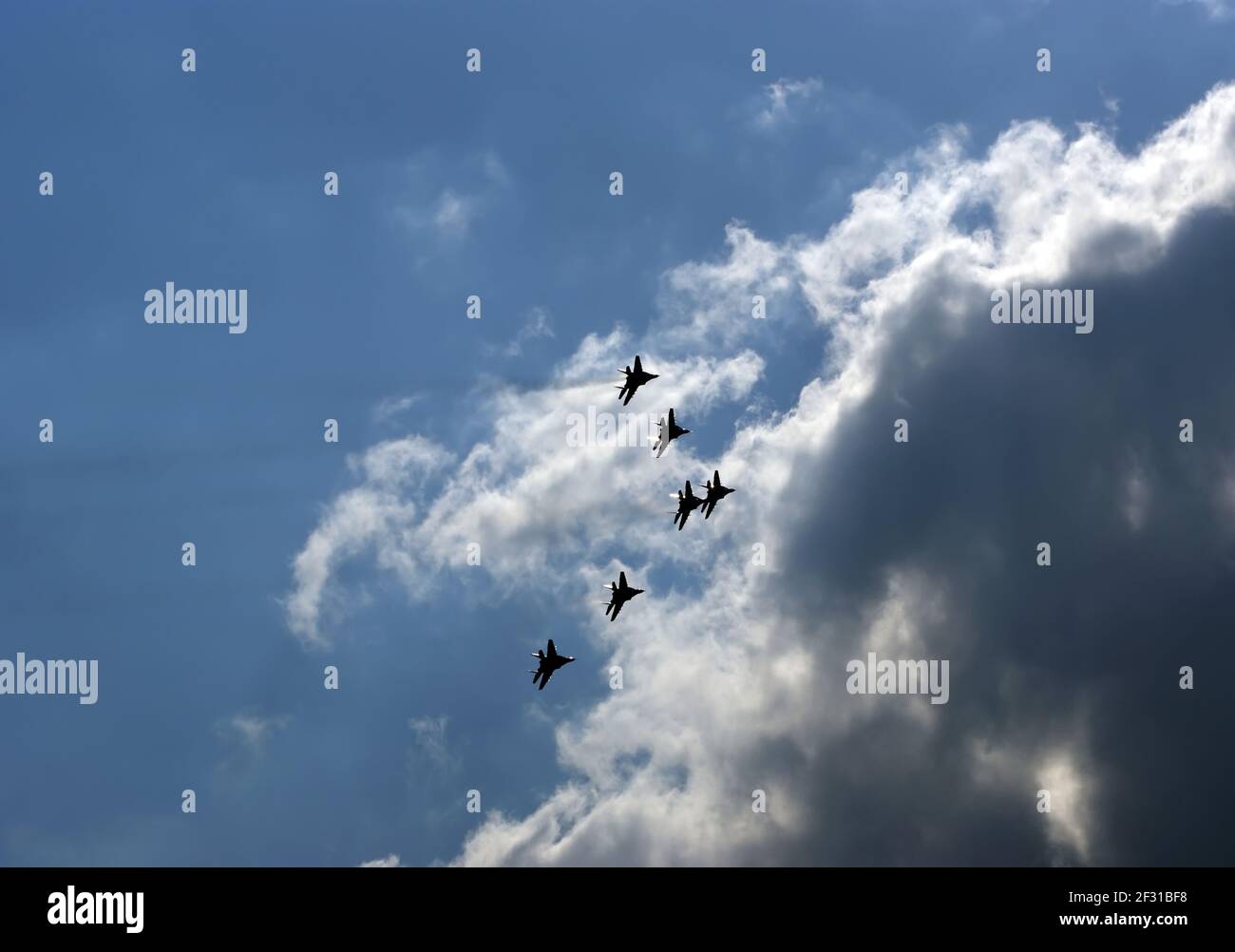 Flight of modern combat fighters on the sky background Stock Photo - Alamy