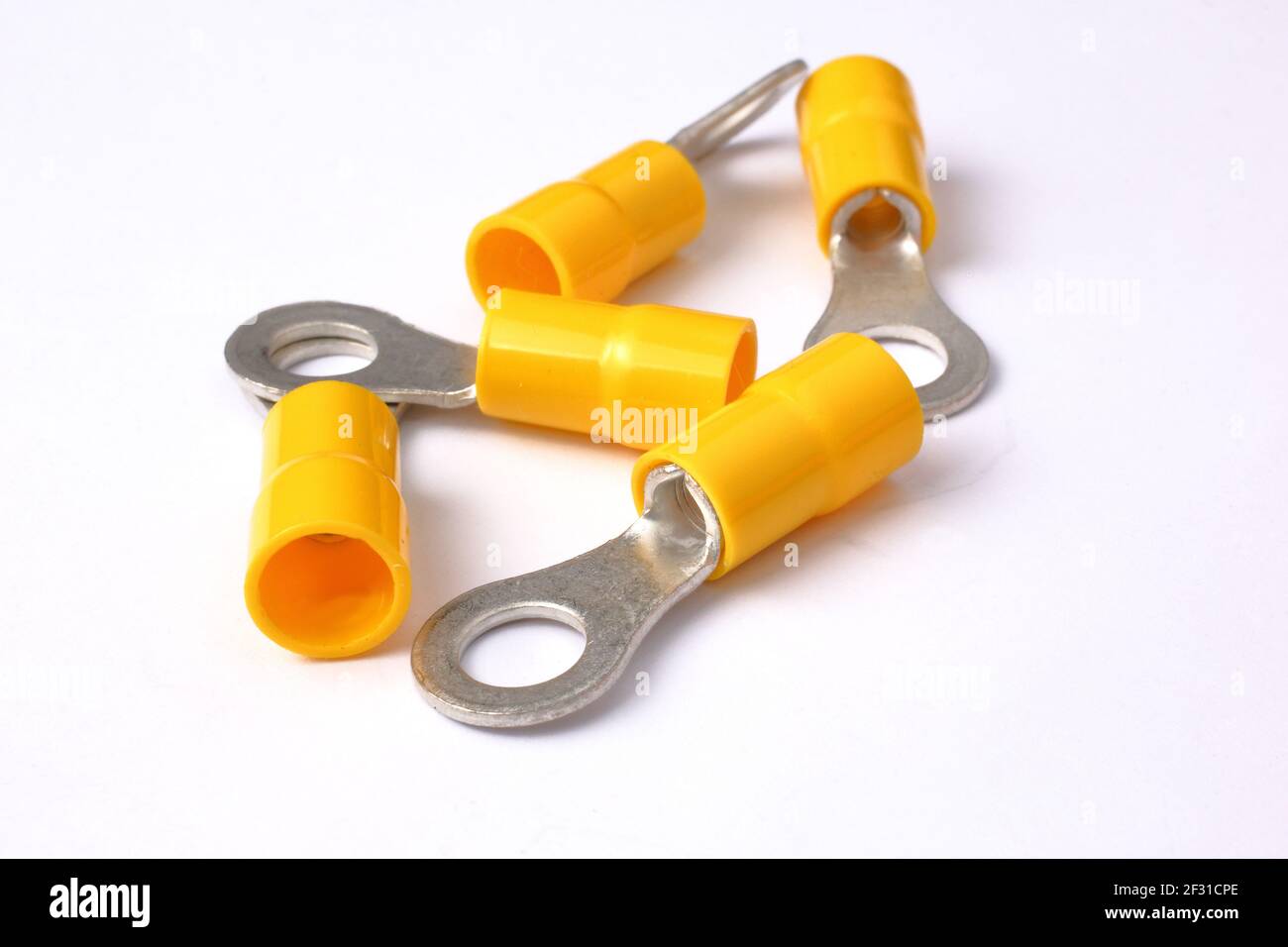 Yellow crimp eyelets for electric cables isolated on white background