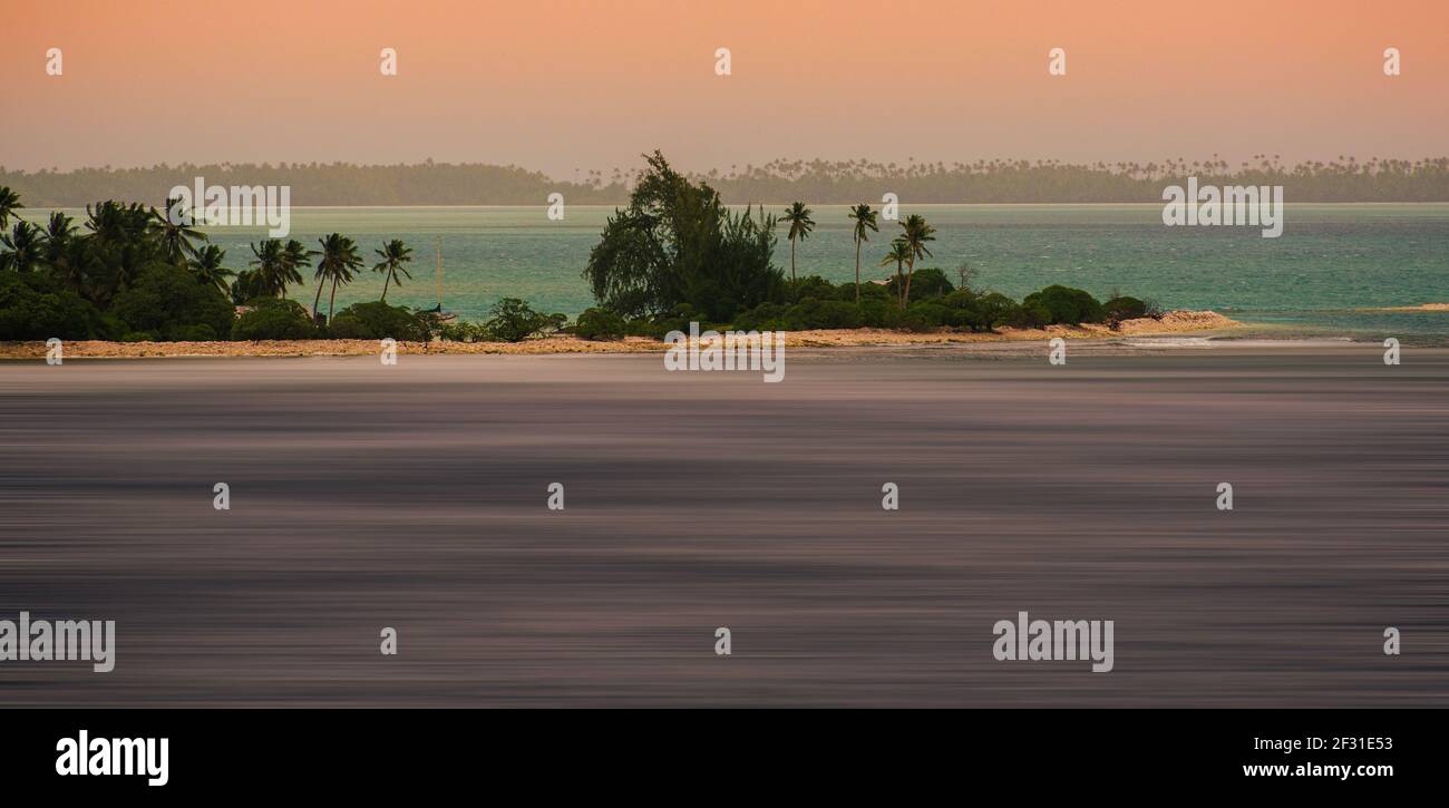 A long distance photo taken while sailing past Fanning Island, part of Kiribati, in the Central Pacific. Kiribati is threatened by rising seas. Stock Photo