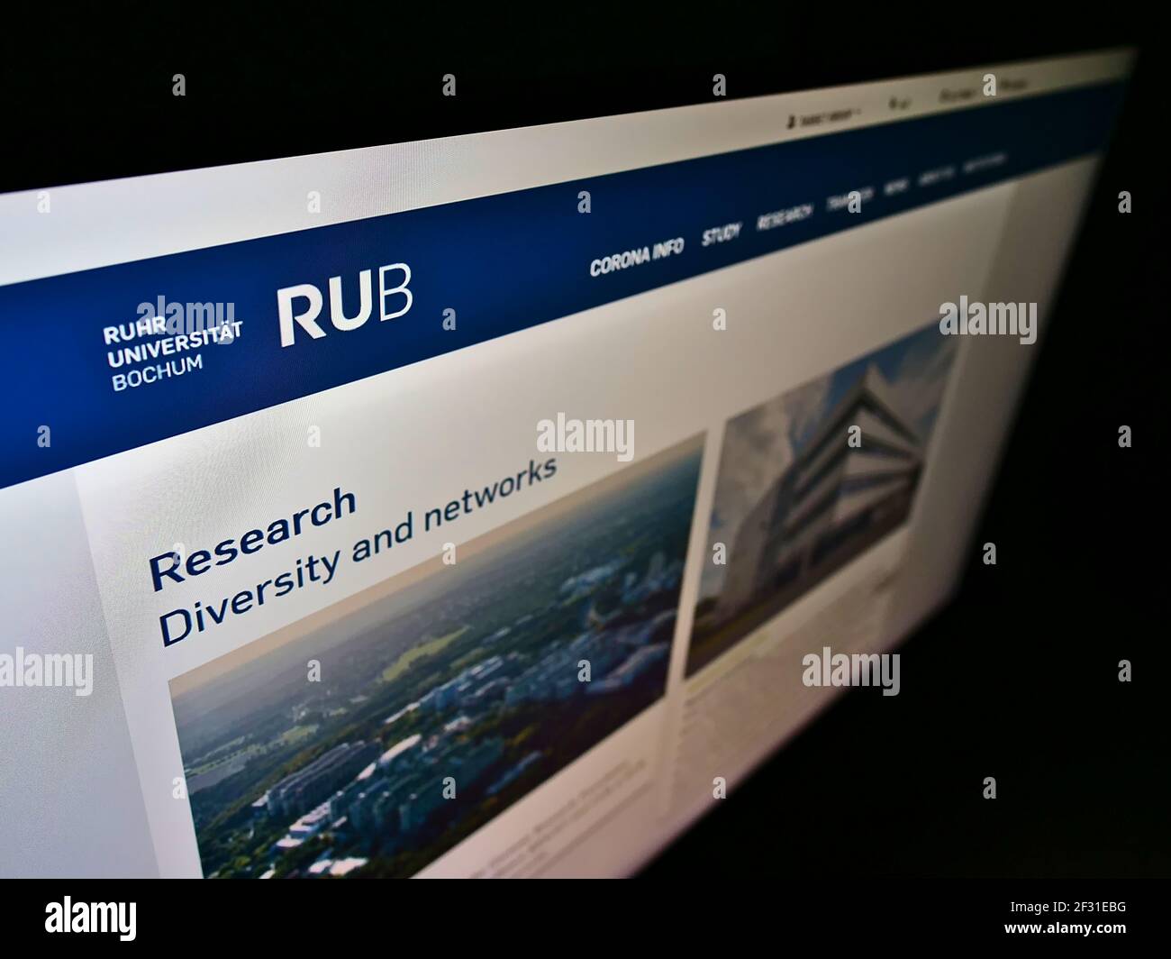 High angle view of webpage with logo of German education institution Ruhr-Universität Bochum (RUB) on monitor. Focus on top-left of screen. Stock Photo