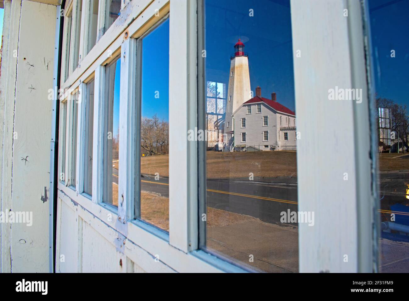Sandy Hook Lighthouse reflected in the window pane of a nearby garage door -42 Stock Photo