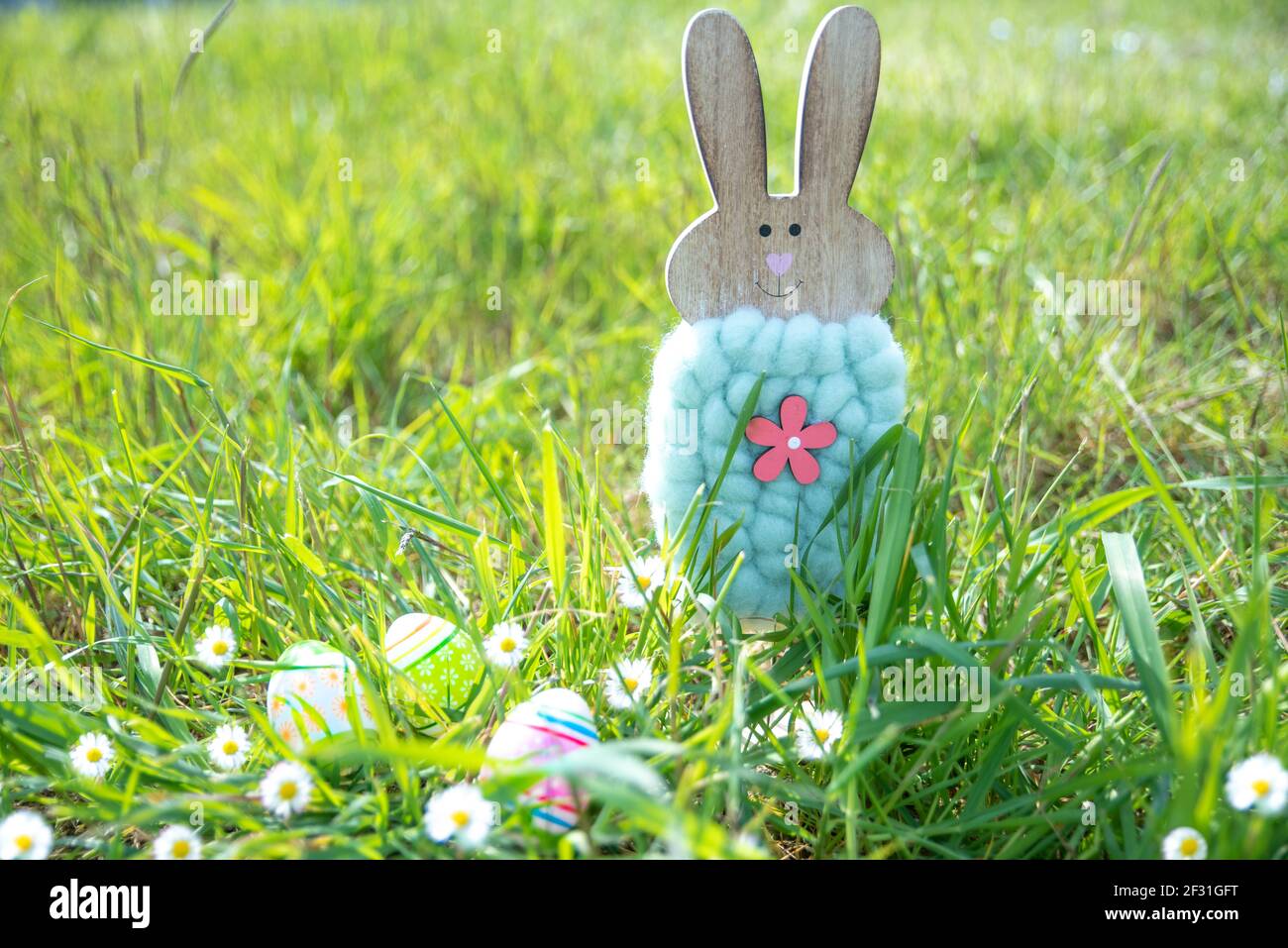 Easter. Rabbit and decorated eggs in flowery field Stock Photo