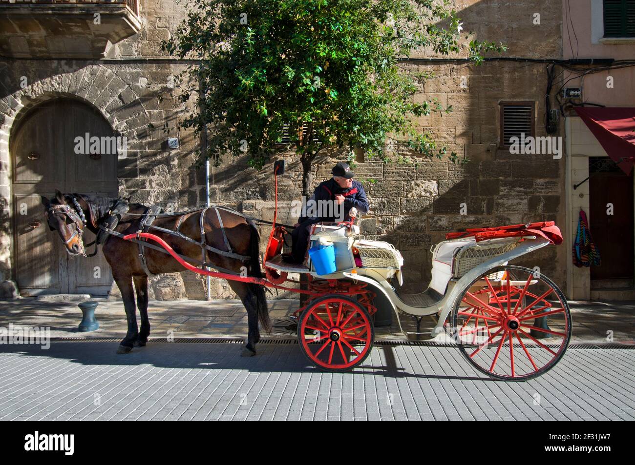 TOURISM SPAIN QUIET EMPTY Horse and carriage & driver in quiet street Mallorca waiting for tourists tourism Spain Concept Conceptual Covid Virus pandemic Europe Visitors Travel Vacation Visitors Economic catastrophe Spain Stock Photo